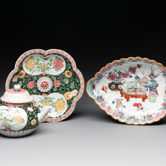 A Chinese famille rose black-ground teapot with cover and stand and a sauce boat, Qianlong