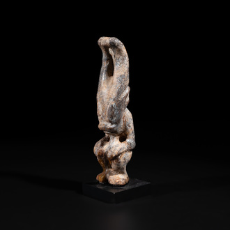 A Chinese jade carving of a crouched figure, possibly Hongshan culture