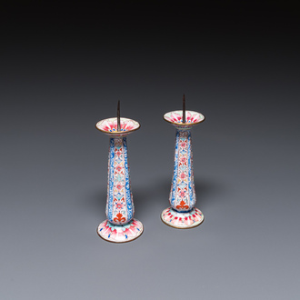 A pair of Chinese Canton enamel candlesticks with floral design, Yongzheng/Qianlong
