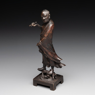 A fine Chinese bronze Luohan holding a sutra, Ming