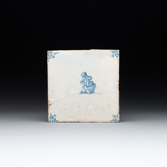 A blue and white Dutch Delft 'lady and pooping child' tile , 17th C.