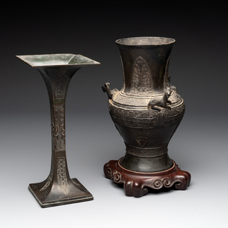 A Chinese archaistic bronze 'gu' vase and a 'hu' vase with rams in relief on a wooden stand, 18/19th C.