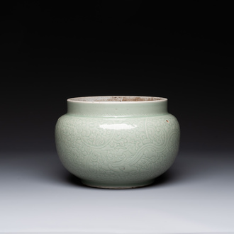 A Chinese incised celadon-glazed bowl with chilong and floral design, Kangxi