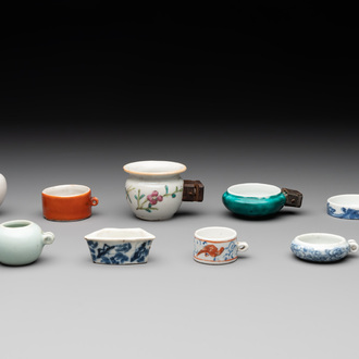 A collection of nine Chinese blue and white, monochrome and famille rose bird feeders, 19th C.