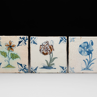 Two polychrome and one blue and white Dutch Delft 'flower' tiles, 17th C.