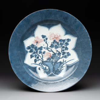 A Chinese blue, white and copper-red powder blue-ground 'peony' dish, Kangxi