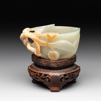 A Chinese jade peach-shaped brush washer on wooden stand, 19th C.