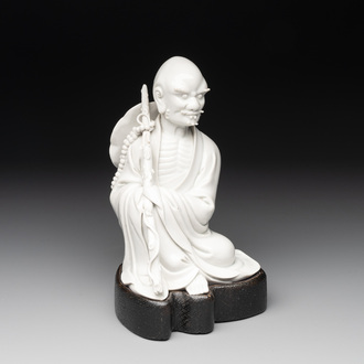 A Chinese Dehua blanc de Chine Luohan on wooden stand, 19/20th C.