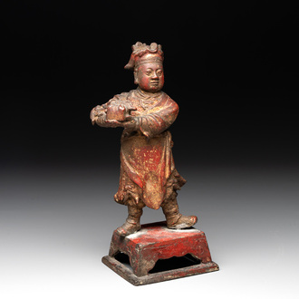 A Chinese gilt-lacquered bronze offering figure on stand, Ming