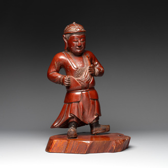 A Japanese lacquered wooden figure of a guardian, 19th C.