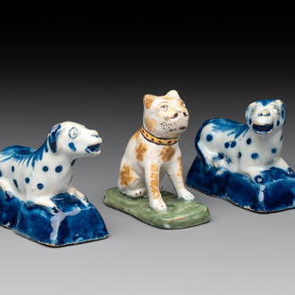 A pair of blue and white Dutch Delft miniature models of dogs and a polychrome dog, 18th C.