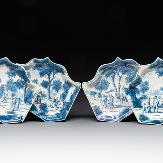 Four fine blue and white Dutch Delft leaf-shaped dishes with travellers in a landscape, early 18th C.
