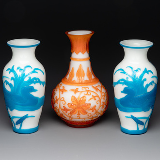 A pair of Chinese blue-overlay white Beijing glass vases with mandarin ducks and a orange-overlay white bottle vase, 19/20th C.