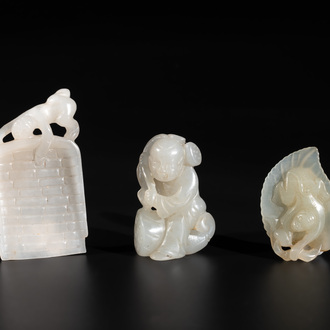 Three Chinese white and celadon jade carvings of a boy and two monkeys, 19th C.