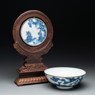 A Chinese blue and white 'Bleu de Hue' 'roosters and chick' plaque in a carved wooden screen and a bowl, 19th C.