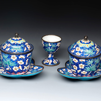 A pair of Chinese blue-ground Canton enamel covered bowls on stands and an egg cup, Qianlong/Jiaqing