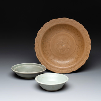 A Chinese Longquan celadon plate and two saucer dishes, Ming
