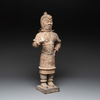 A large Chinese painted pottery figure of a standing guardian, Tang