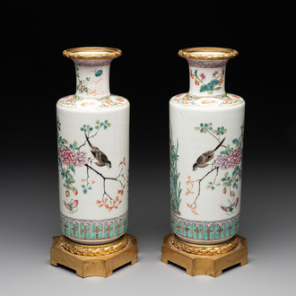 A pair of Chinese famille rose gilt-bronze-mounted 'birds among flowering branches' vases, 19th C.
