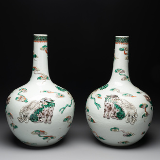 A pair of Chinese famille verte relief-decorated 'animals' vases, 19th C.