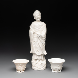 Two Chinese Dehua blanc de Chine cups and a figure of Liuhai, 18/19th C.