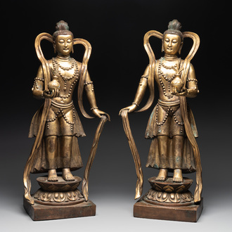 A pair of large Chinese gilt bronze offering figures on stand, 19th C.