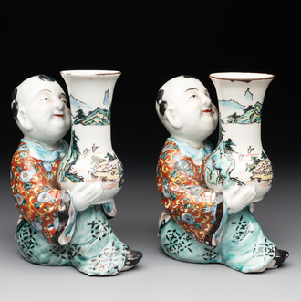 A pair of Japanese polychrome boy-shaped vases, 19th C.