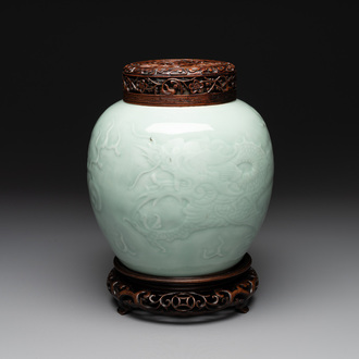 A Chinese celadon-glazed 'dragon' jar with reticulated wooden cover and stand, Qianlong