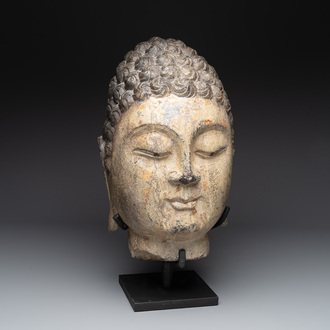 A large Chinese stone head of Buddha with traces of gilding and polychromy, Ming