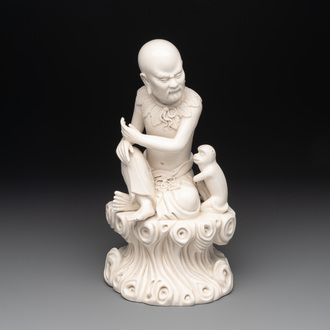 A Chinese Dehua blanc de Chine group of a seated Luohan with a monkey, 20th C.