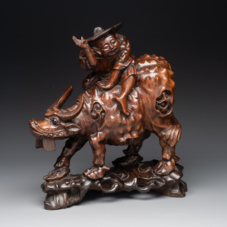 A Chinese carved wooden group of a boy riding a water buffalo, 20th C.