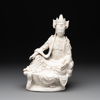 A Chinese Dehua blanc de Chine seated Guanyin holding a sutra, 20th C.