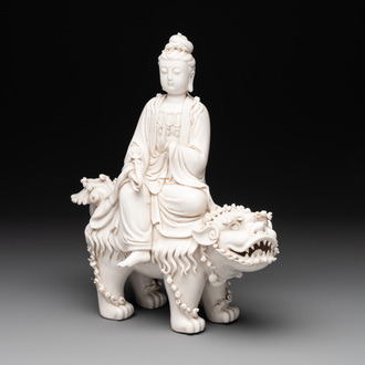 A Chinese Dehua blanc de Chine Guanyin with a ruyi sceptre seated on a Buddhist lion, 20th C.