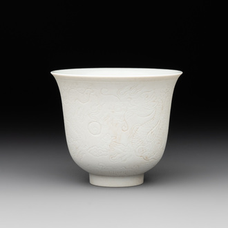 A Chinese white-glazed biscuit 'dragon' cup, Kangxi mark, 19th C.