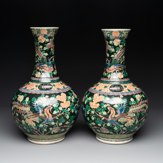 A pair of Chinese famille verte black-ground 'phoenix' bottle vases, Qianlong mark, 19th C.