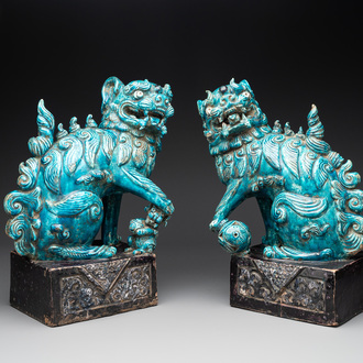 A pair of Chinese turquoise-and-aubergine-glazed Buddhist lions on stands, probably Swatow kilns, 19th C.