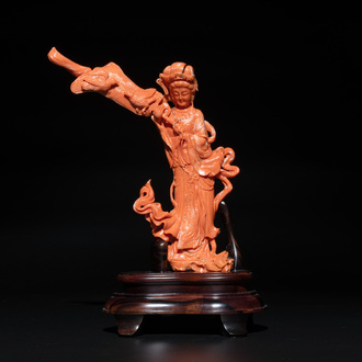 A Chinese red coral female deity holding a fan, 19/20th C.
