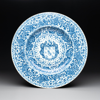A large Chinese blue and white armorial dish with the arms of the Coelho family, Kangxi