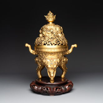 A large Chinese precious stone-inlaid gilt bronze 'elephant' tripod censer and cover on wooden stand, 19th C.