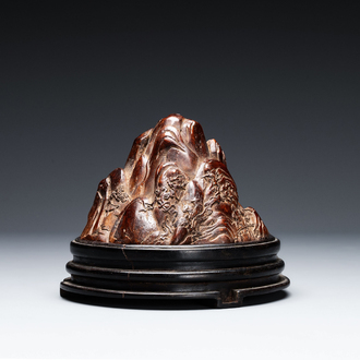A Chinese agarwood carving of a mountain on wooden stand, 18/19th C.