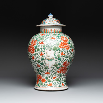 A Chinese wucai 'boy and peony scroll' vase and cover, 17th C.