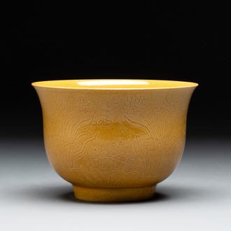 A Chinese yellow-glazed 'anhua' 'carp and lotus' bowl, Kangxi mark, 19th C.