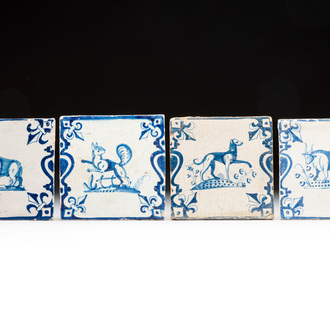 Four blue and white Dutch Delft 'candelabra' tiles with animals, 17th C.