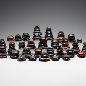 A large collection of 91 Chinese wooden stands, 19/20th C.