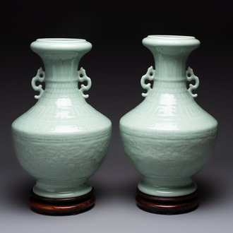 A pair of Chinese celadon-glazed vases with 'anhua' design on wooden stands, Qianlong mark, 19th C.