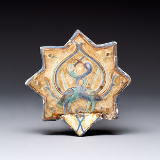 A polychrome Kashan relief-moulded star-shaped tile with herons, Persia, 14th C.