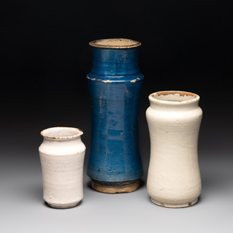 A blue-glazed albarello and two white-glazed albarelli, Spain, 17th C.