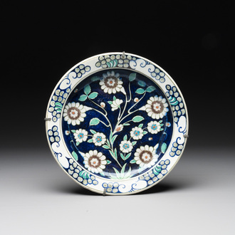An inscribed blue-ground Iznik-style dish, 19th C.