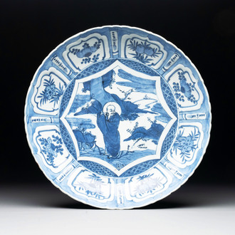 A Chinese blue and white 'kraak' dish with Damo in a landscape, Wanli