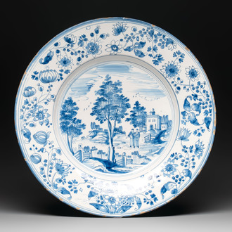 A large blue and white 'landscape and figures' dish, Frankfurt, 17th C.